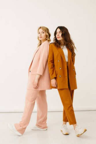 image70 Stylish young women in pastel outfits standing together, fashion concept - stock photo